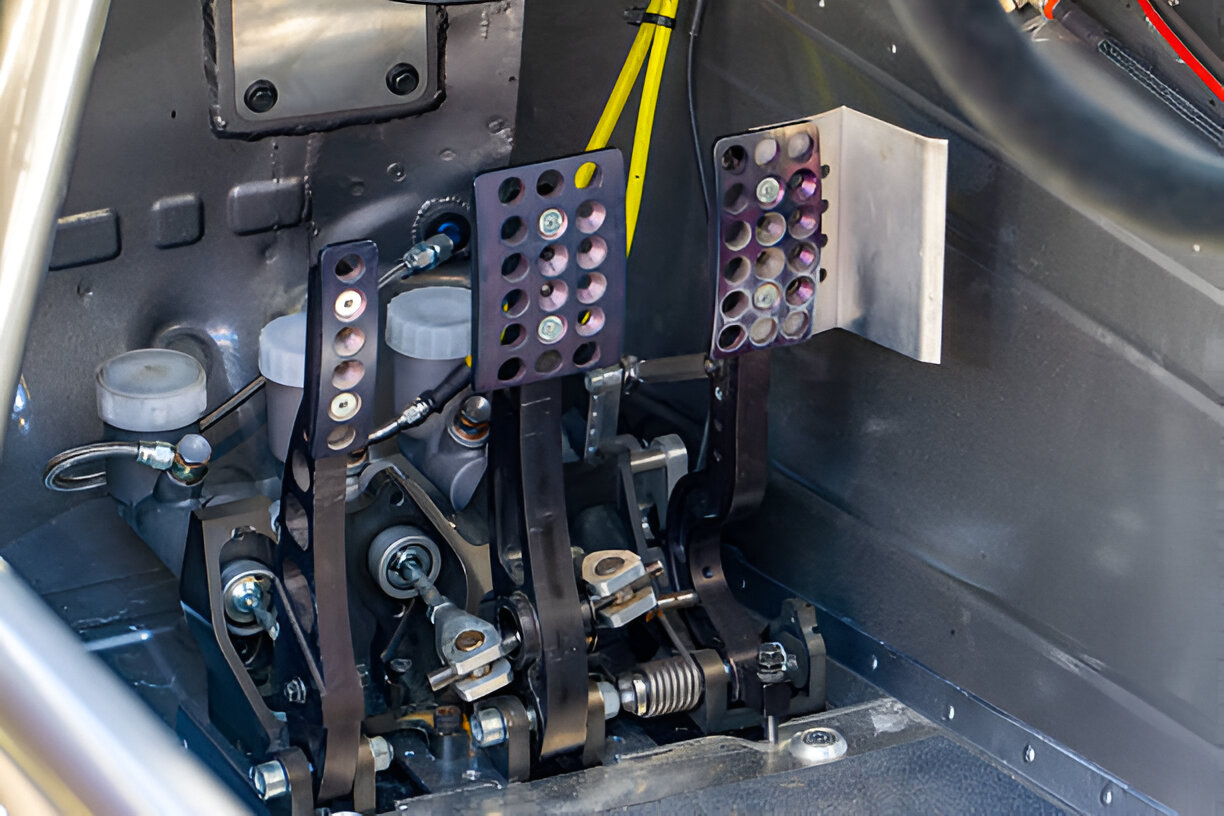 Close-up of complex mechanical pedal system in vehicle interior