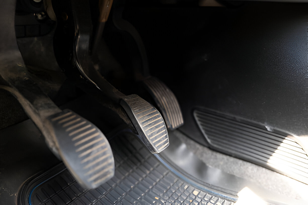 Car floor with brake and gas pedals in textured metallic finish