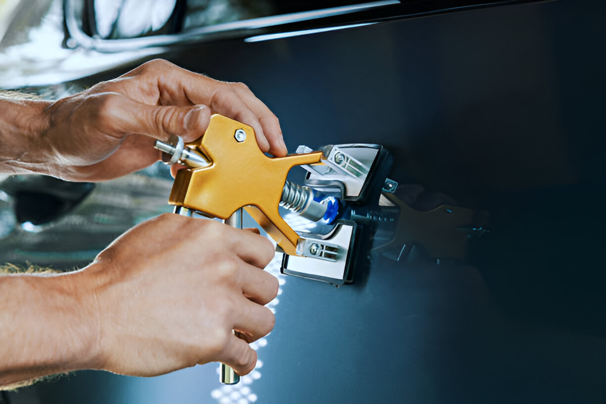 Yellow spray gun being used to apply paint or coating on surface