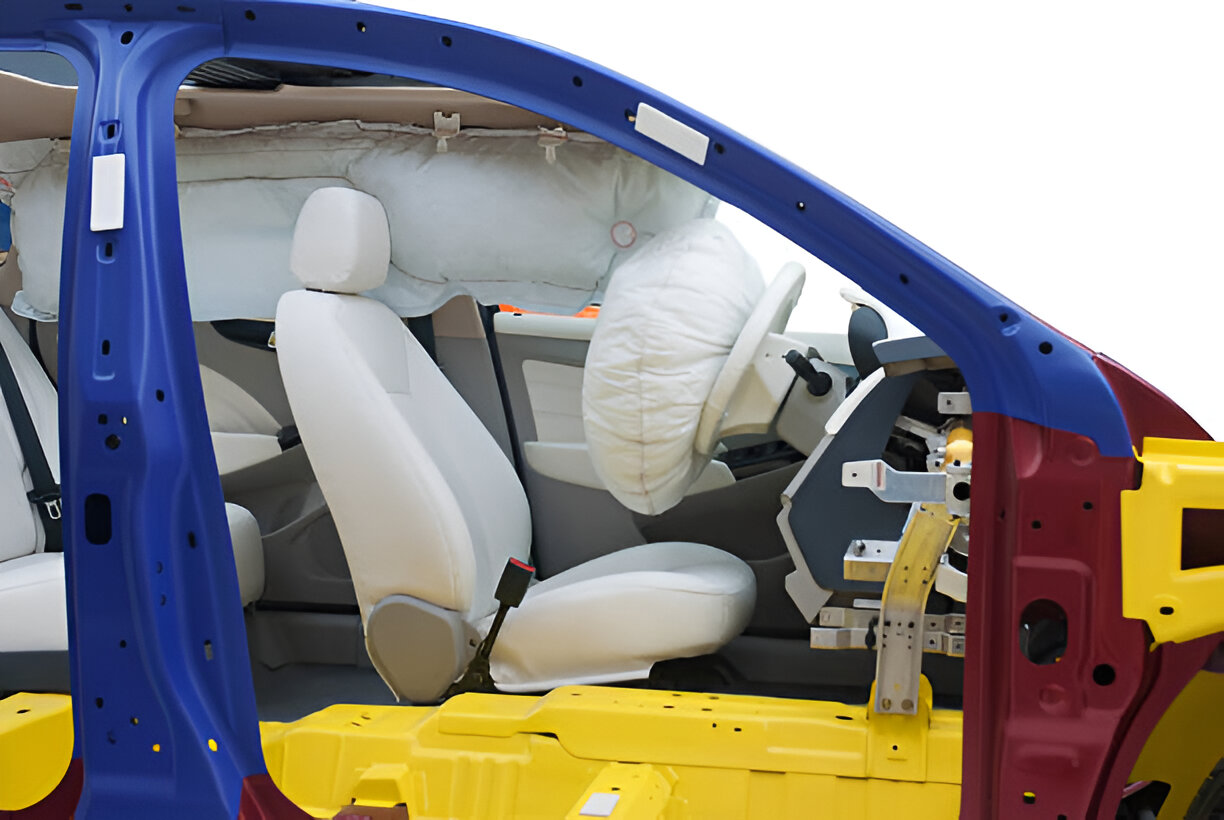 Car safety demonstration with deployed airbags and white interior seats