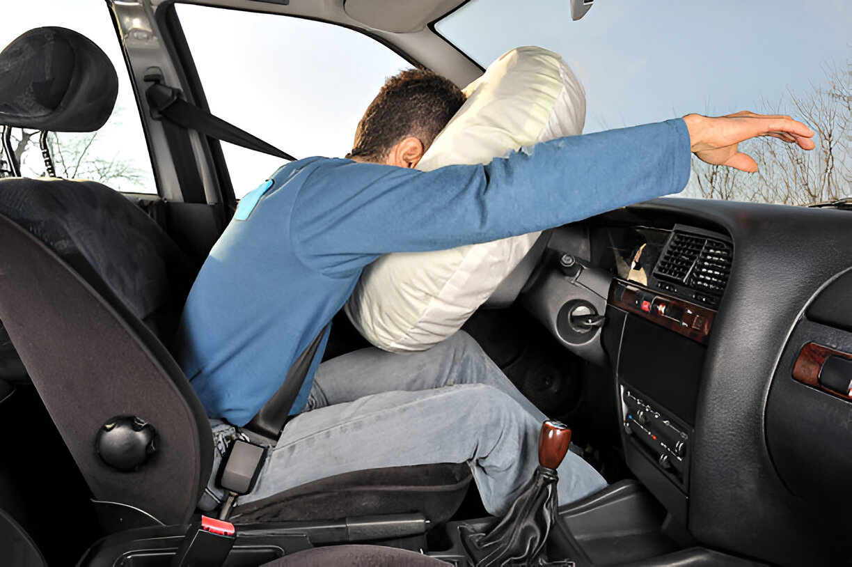 Driver with deployed airbag after a car collision or accident