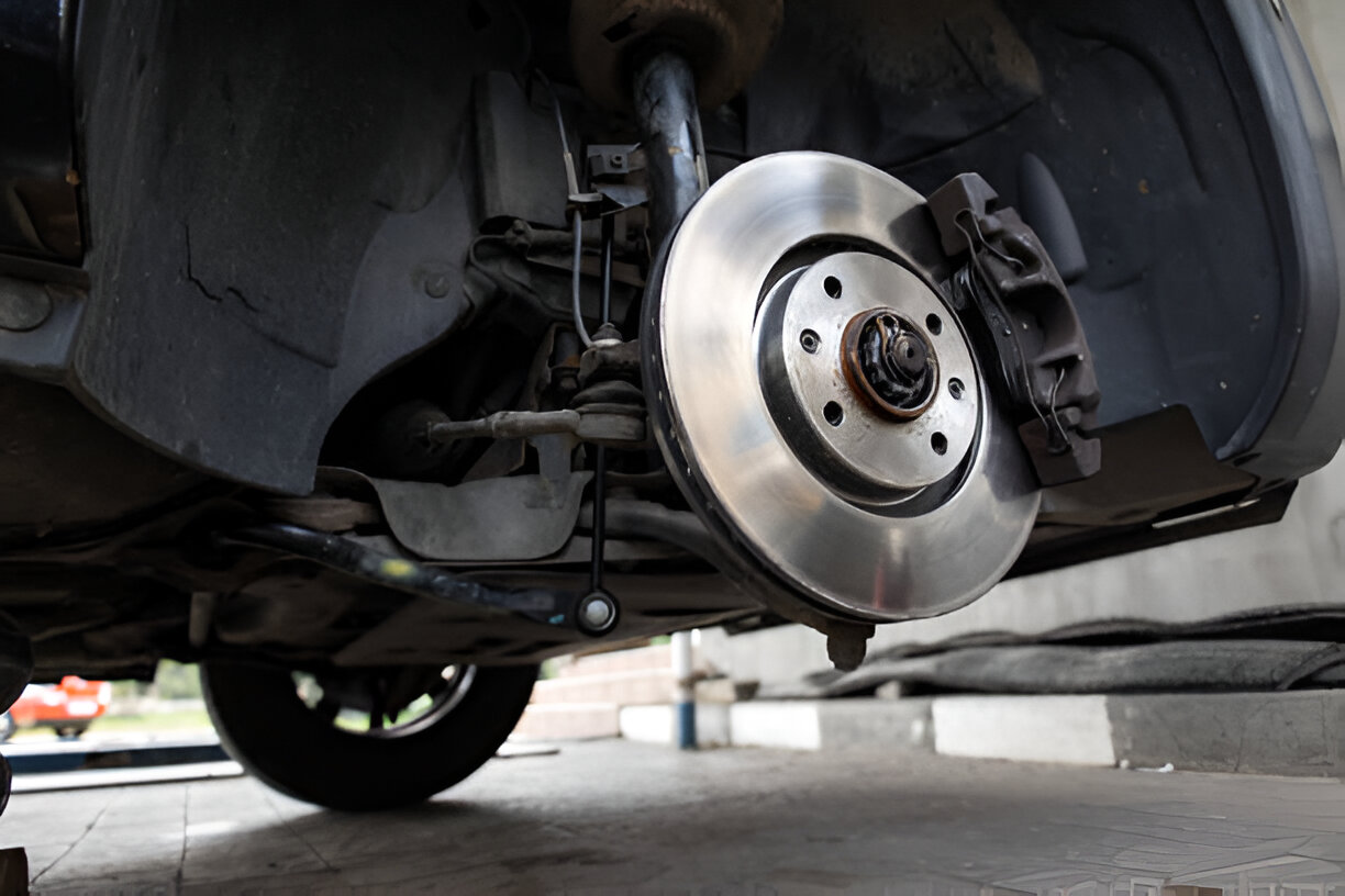 Car brake disc and suspension system during vehicle maintenance
