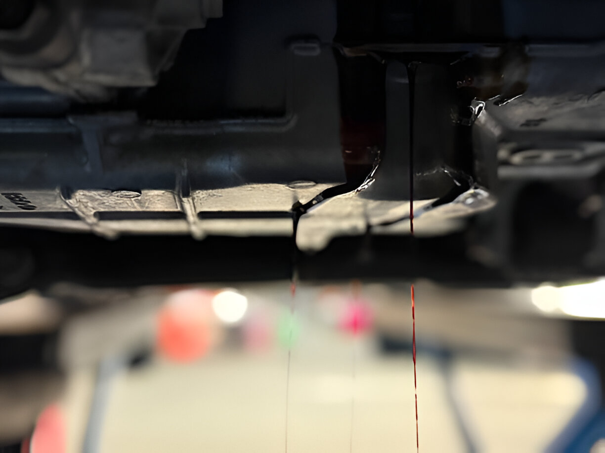 Close-up of printer mechanism with red ink droplet suspended in mid-air