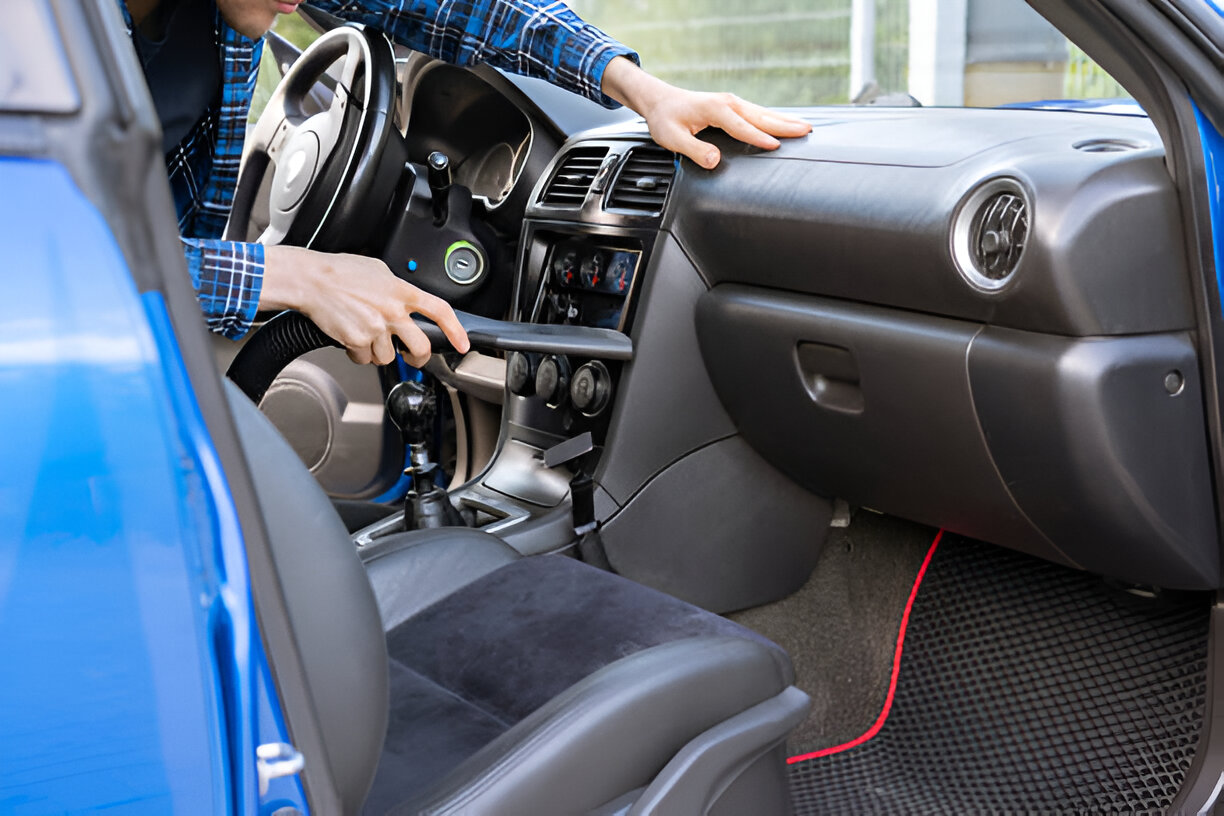 Interior of blue car with manual transmission and driver shifting gears