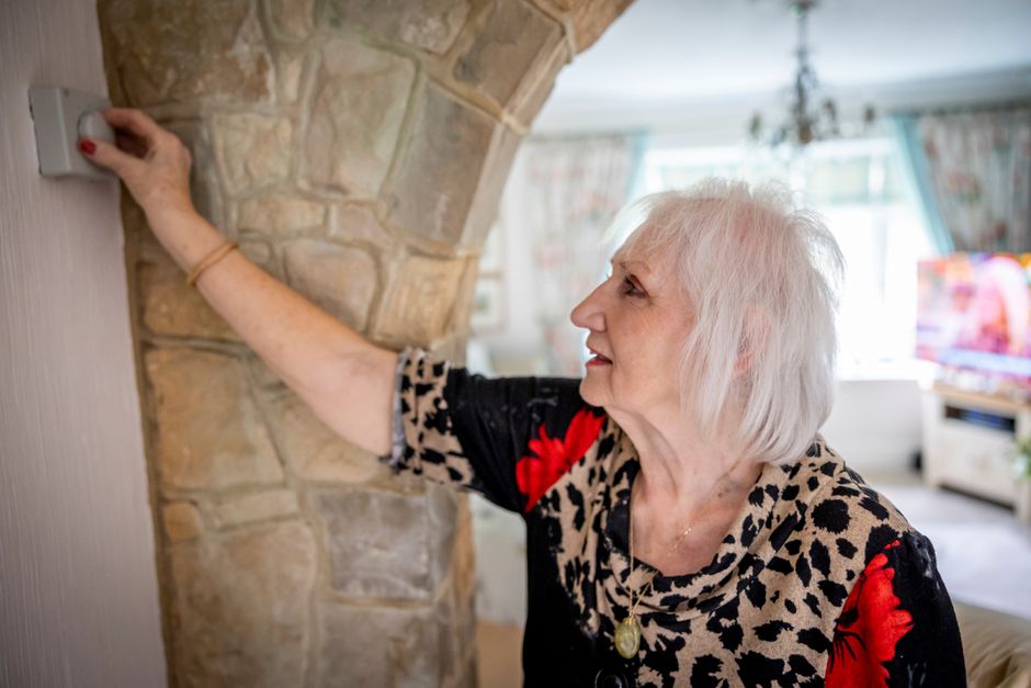 homeowner checking thermostat - heating contractor ankeny homeowner checking thermostat - heating contractor ankeny