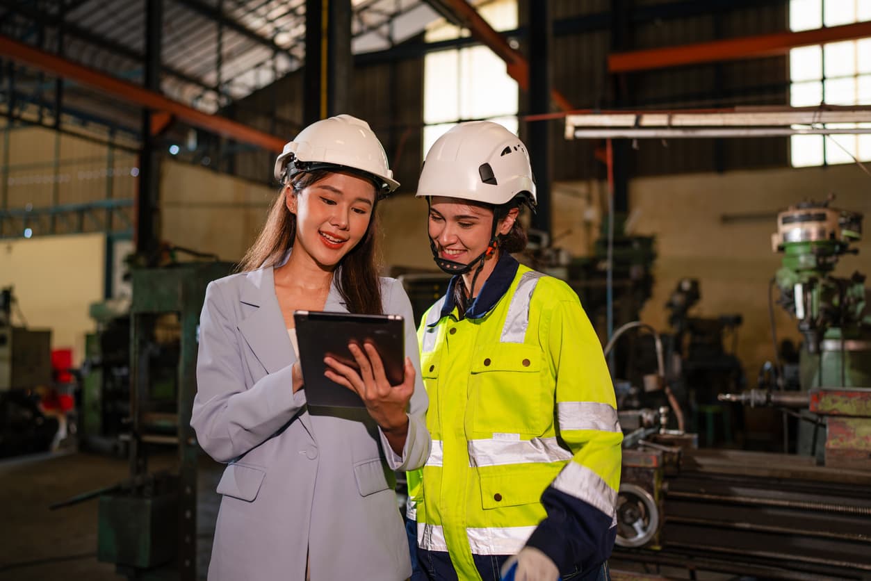 A manufacturing leader chatting with an employee.