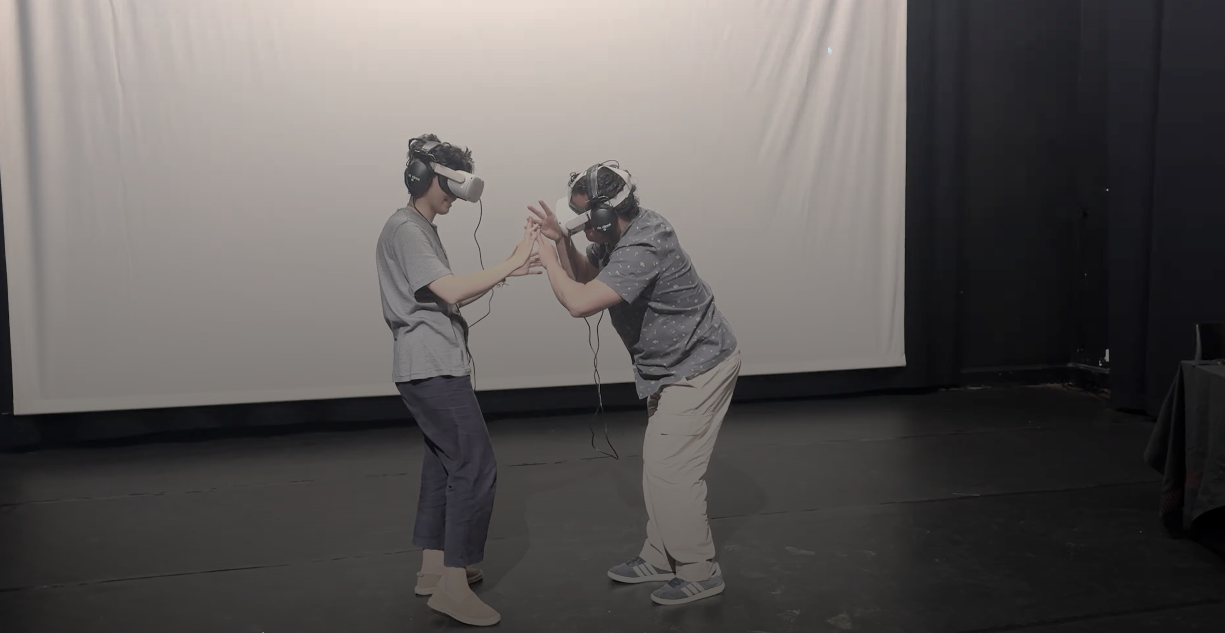 A performance in action: 2 people interacting in VR in Hands Whisper Quietly
