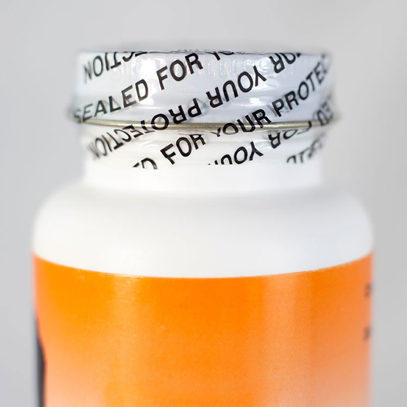 A picture of a medicine bottle with a shrink band that reads "sealed for your protection."