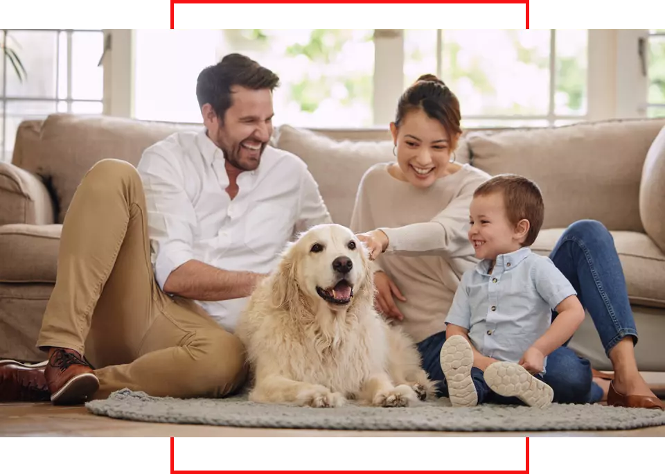 Family enjoying time together with a golden retriever in a cozy living room, emphasizing comfort and happiness in a home environment.