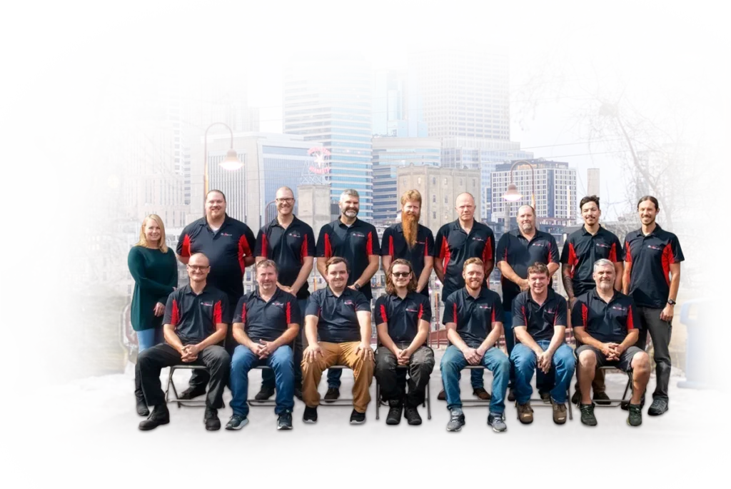 Team of Stafford Home Service employees in branded shirts, posing in front of a city skyline, showcasing expertise in residential electrical and HVAC services.