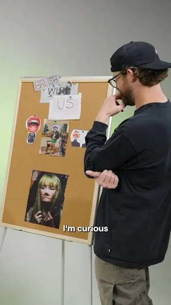 Creator looking at an inspiration board in a studio