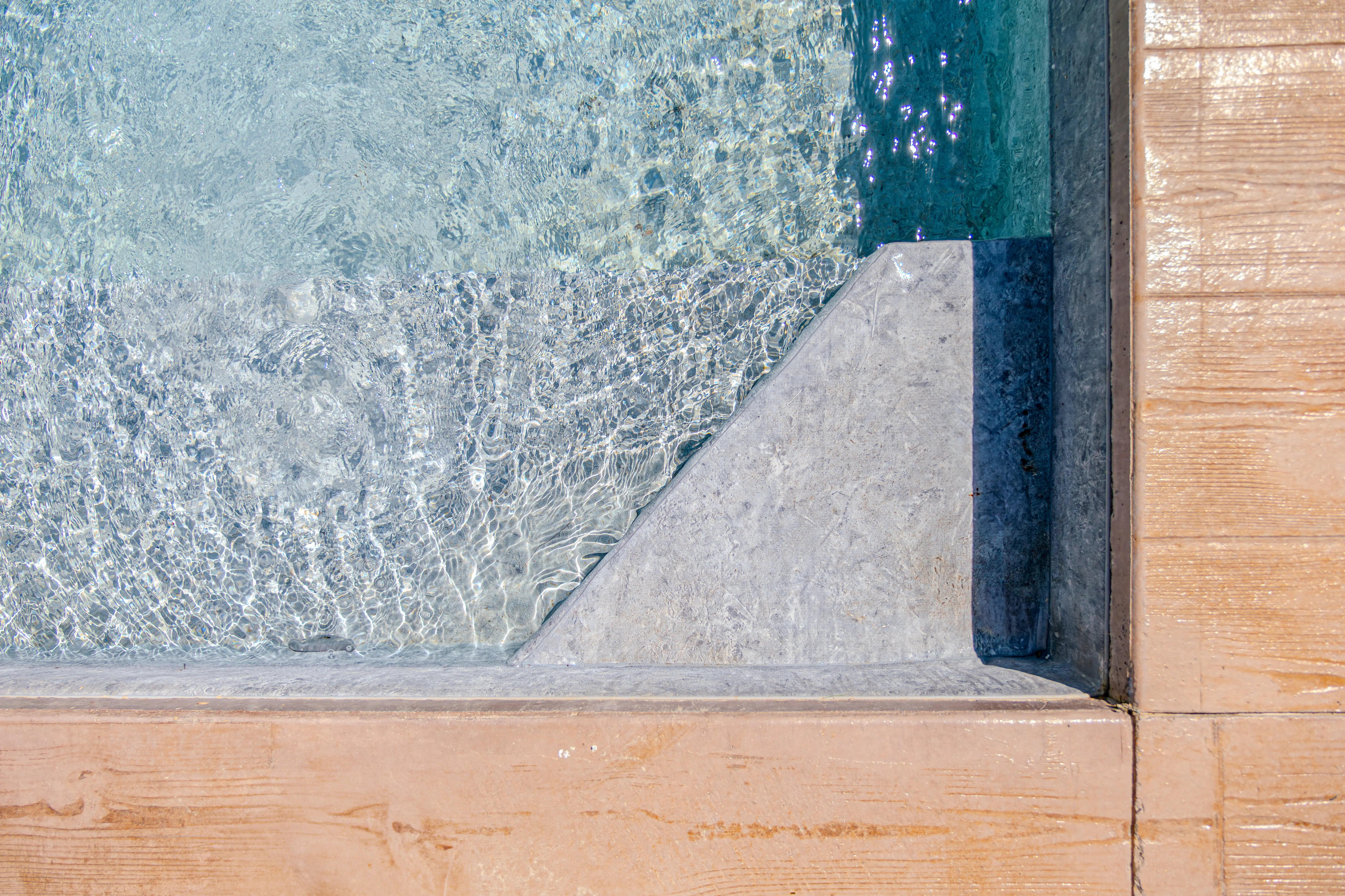A picture of the swimming pool taken from the top of it.