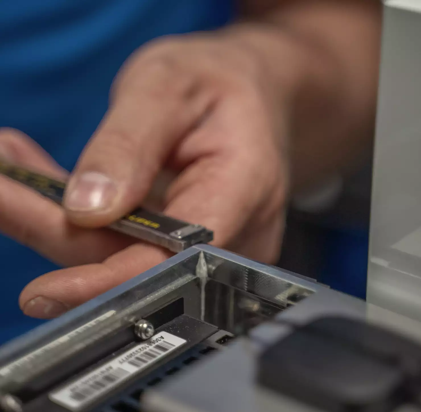 Closeup of a person measuring the size of electric components in a WTW device