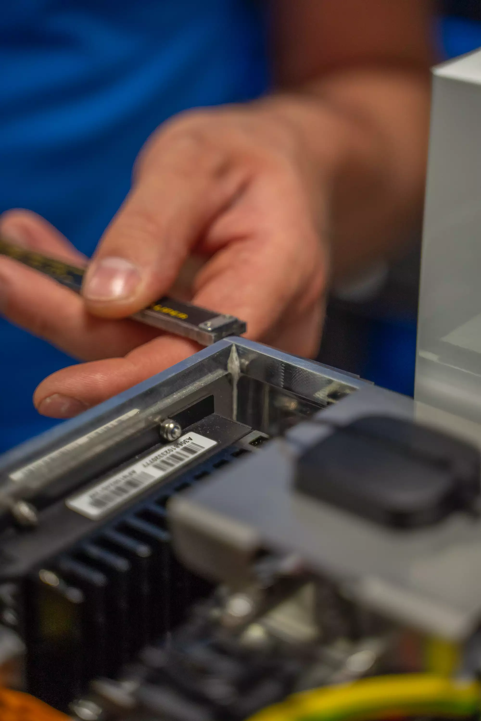 Closeup of a person measuring the size of electric components in a WTW device