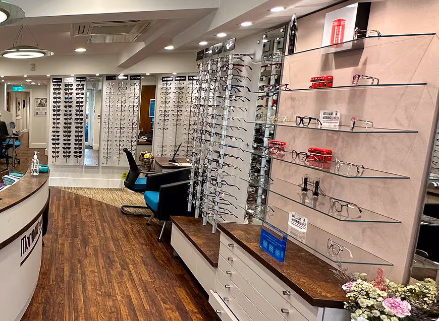 Interior of an optical store with eyeglasses displays and reception desk