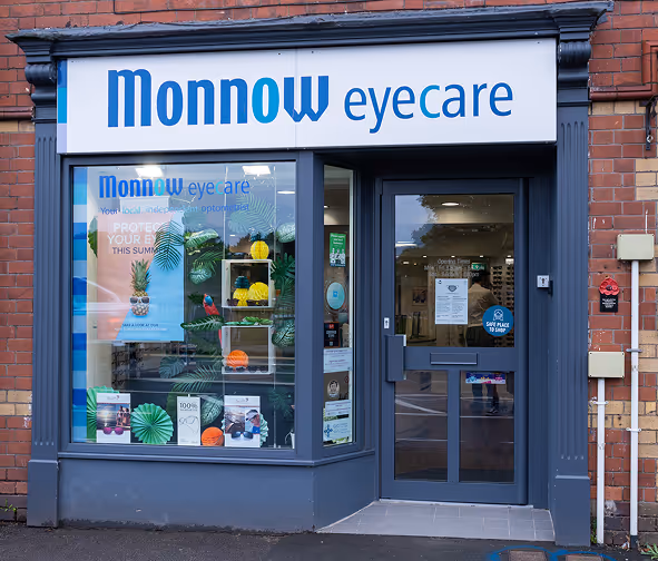 Monnow eyecare storefront with tropical-themed window display and blue signage