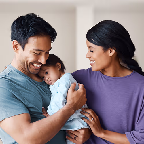Parents holding an infant.