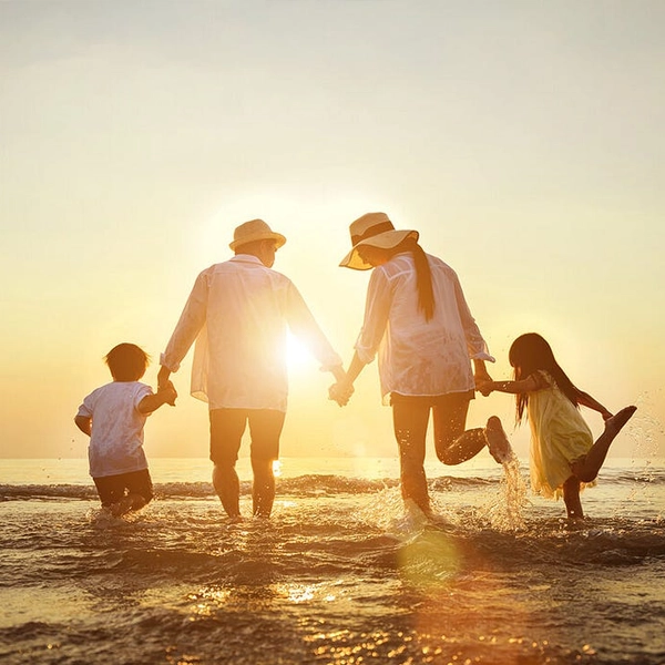 A family walking on the beach.