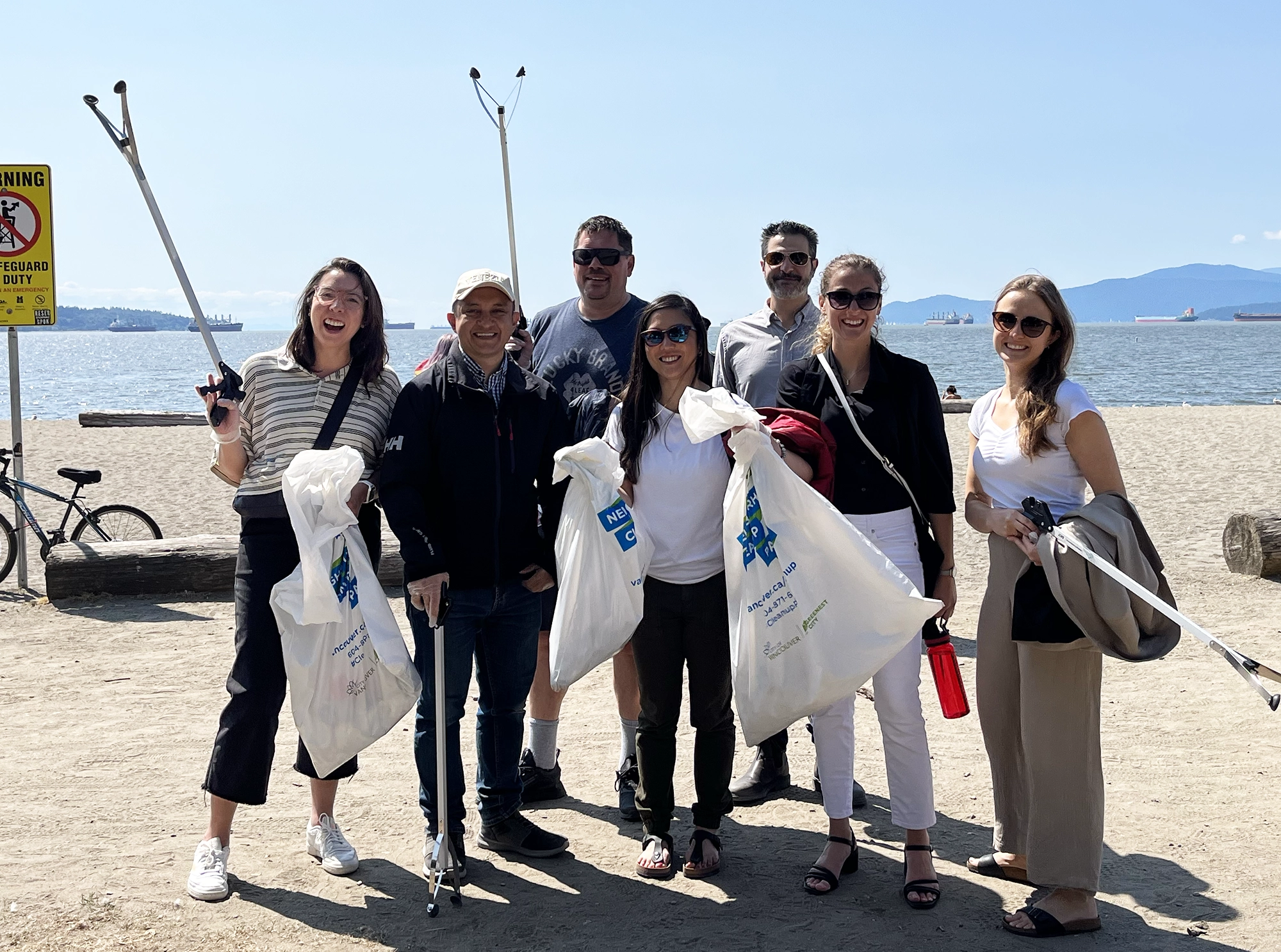 A group photo of Thrivers at beach cleanup.