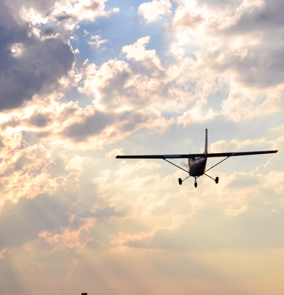 Aircraft flying through clouds in the sky