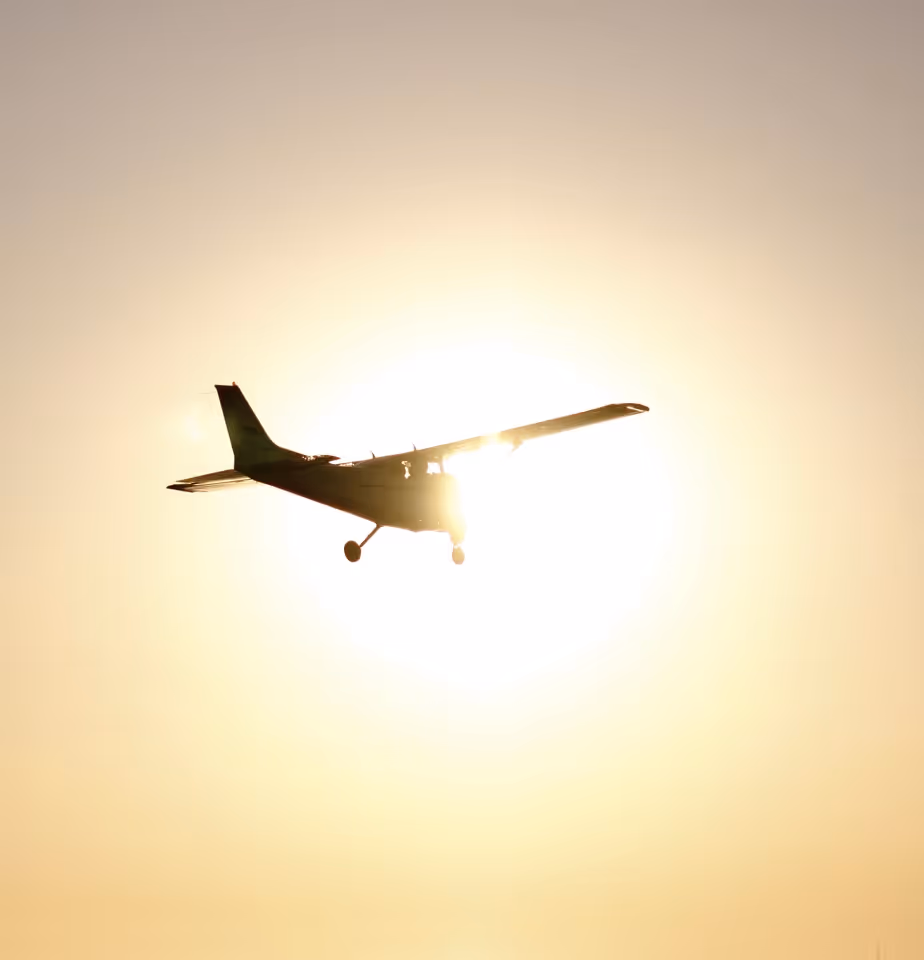 Silhouette of Cessna flying into the sunset.