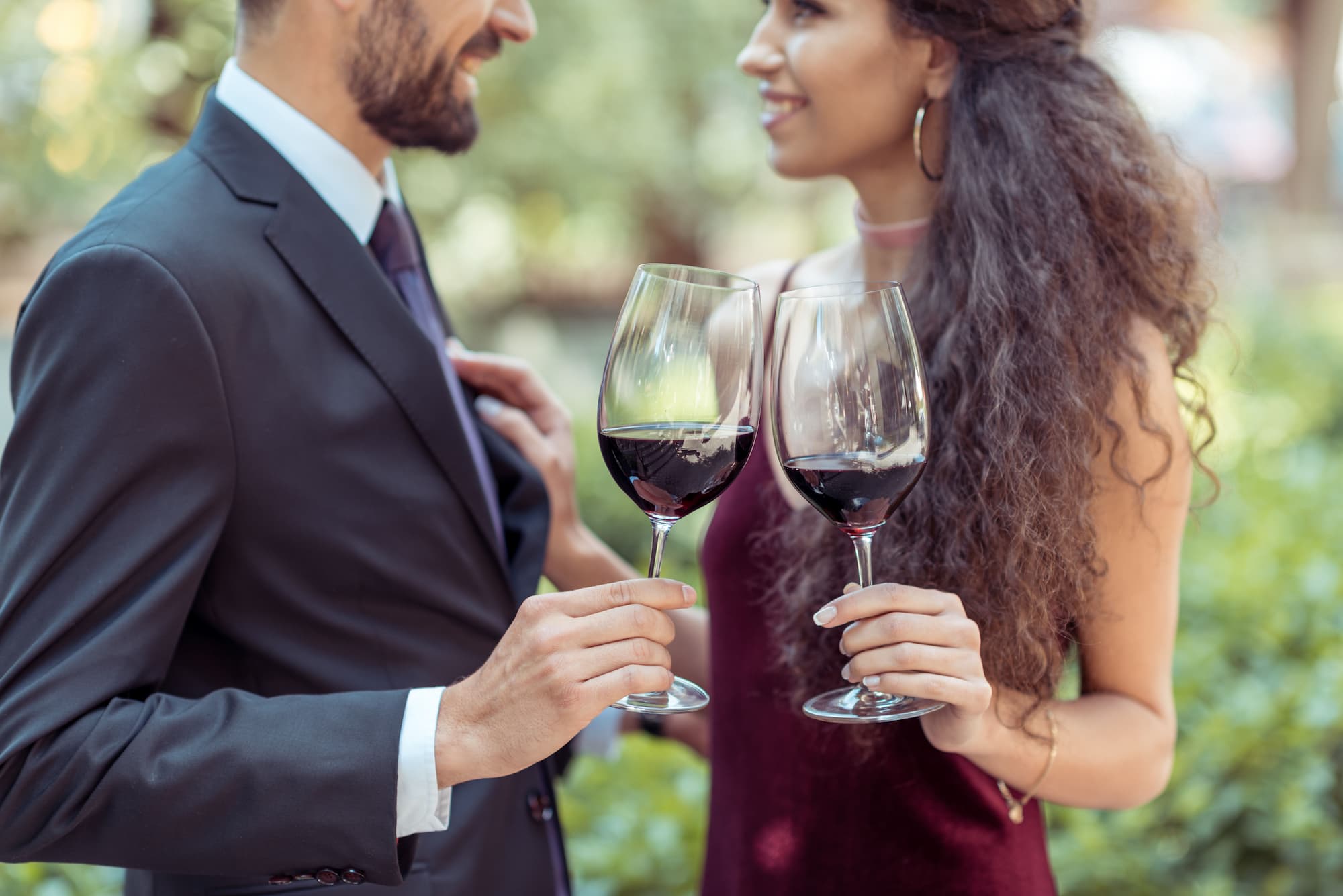 happy couple cheers-ing their wine