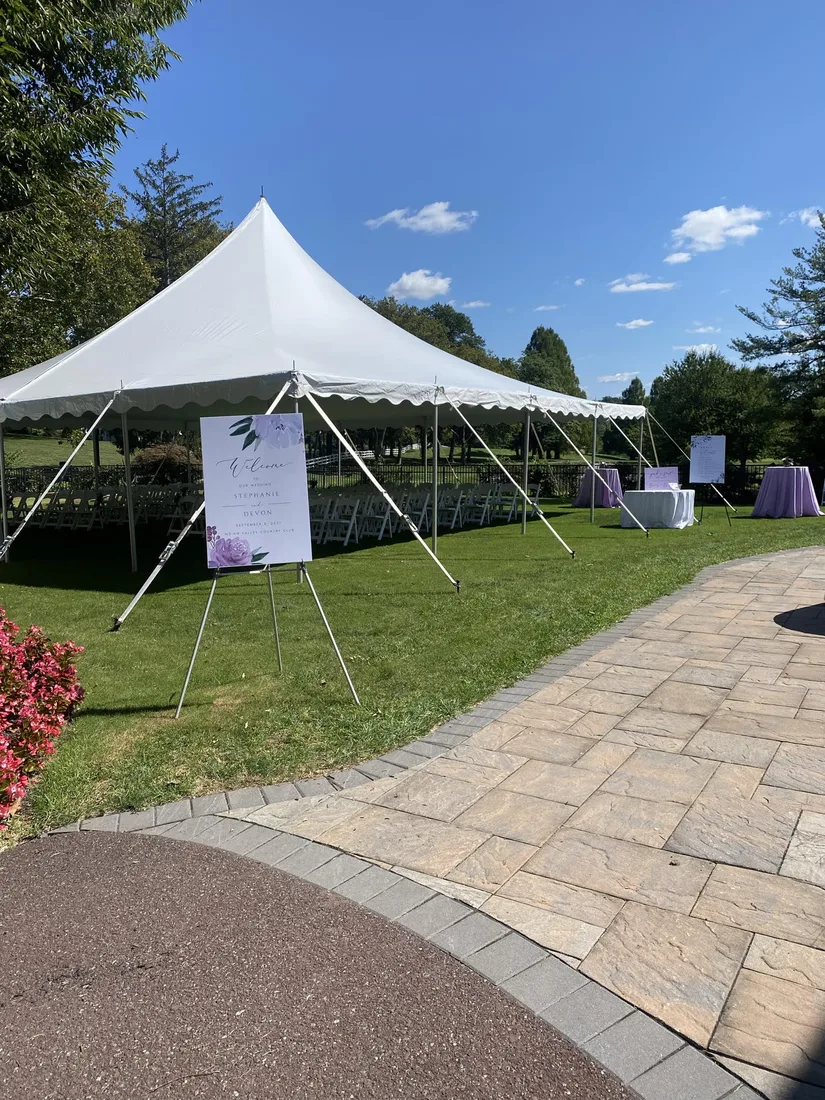 HPR high-peak tent installed beside a paved backyard patio with open entry space.