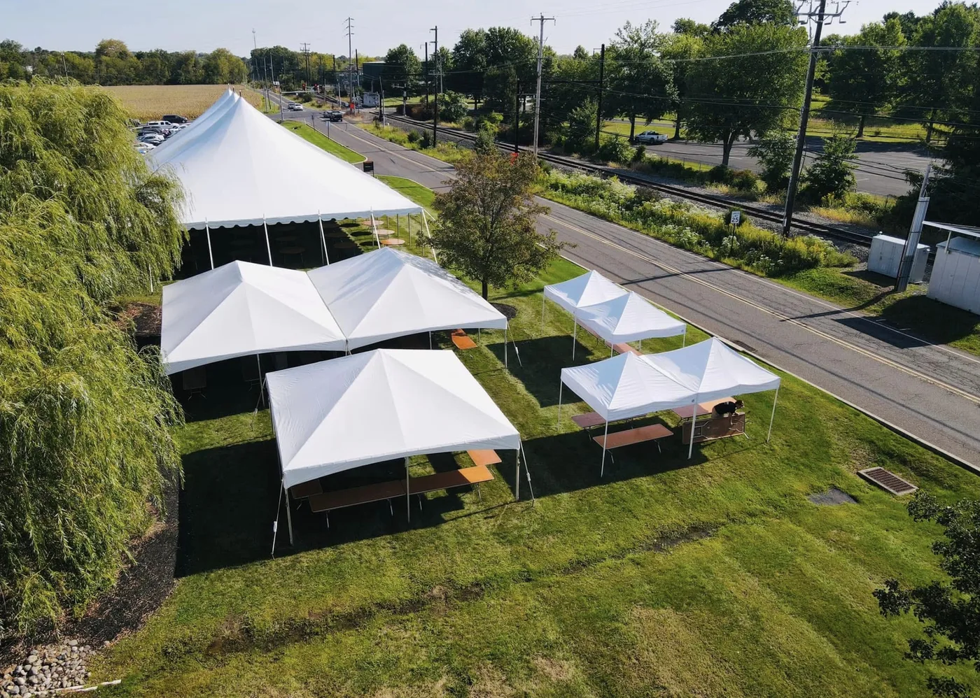 Aerial HPR project photo showing large and small white tents arranged around service and guest routes.