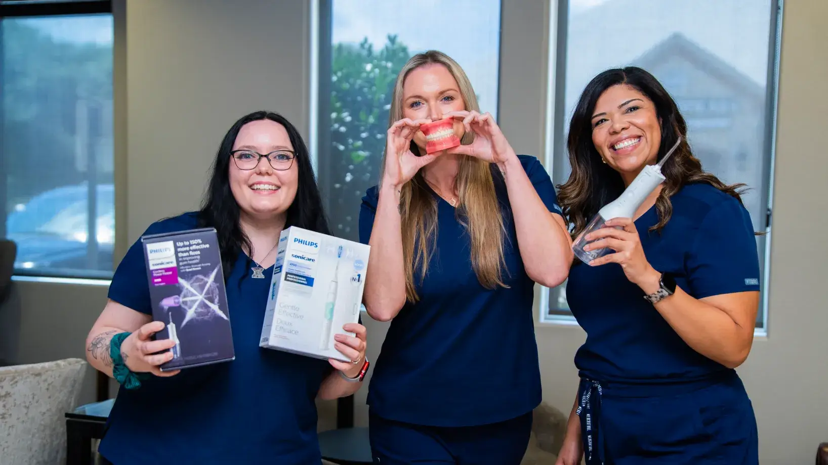 Dental office hallway with a modern X-ray machine in a glass-walled room.