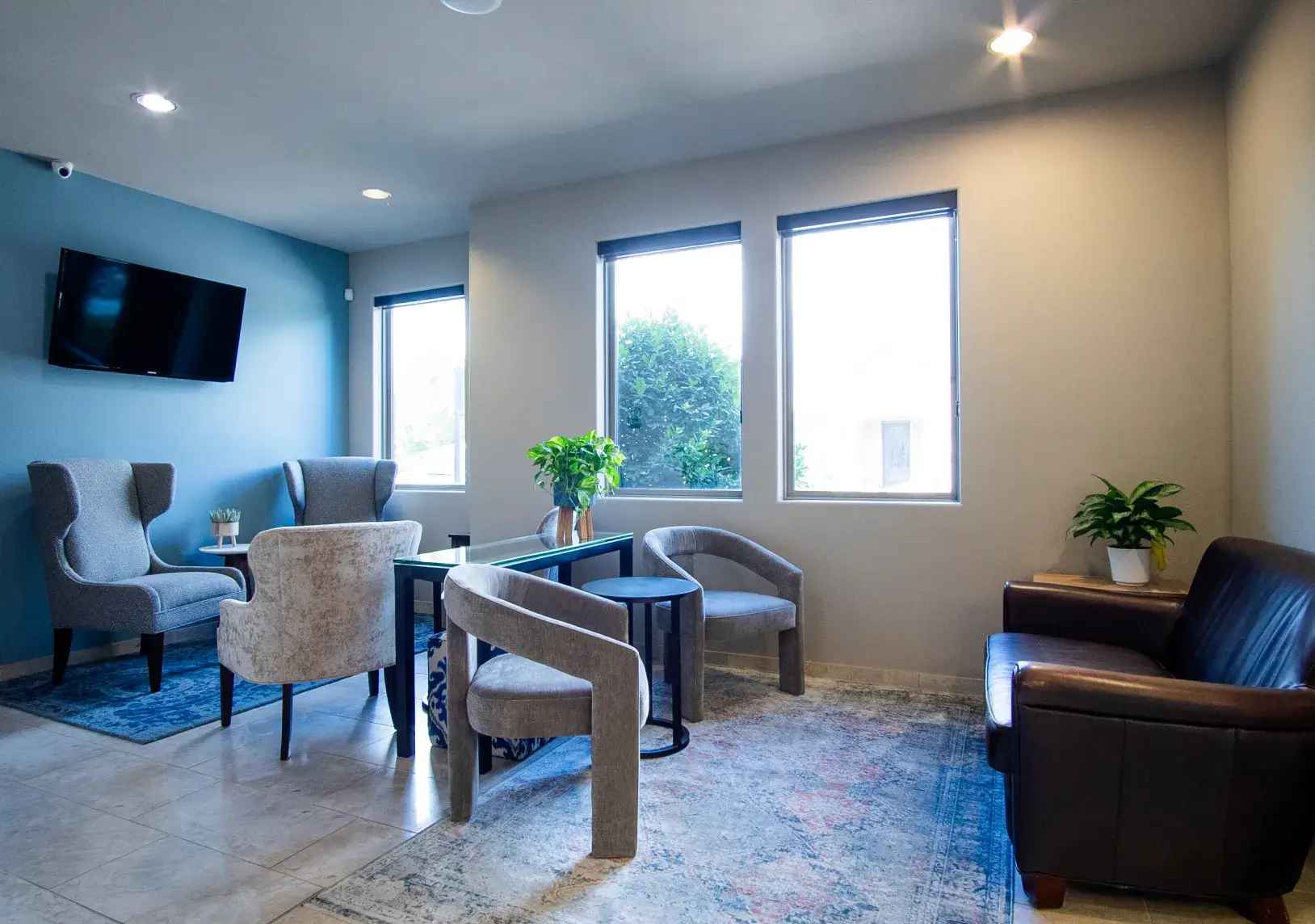 An empty dentist office reception area with a small desk and a door leading to another room.