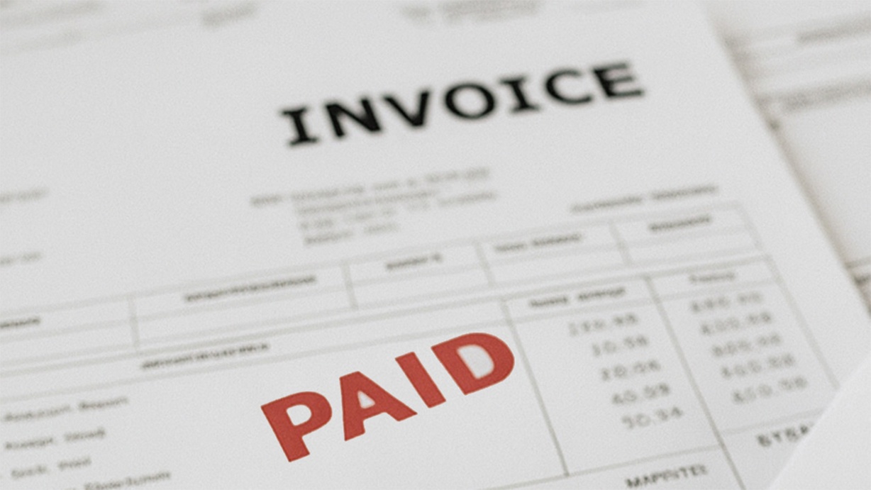 Invoice document stamped with "PAID" in red, indicating successful payment processing.