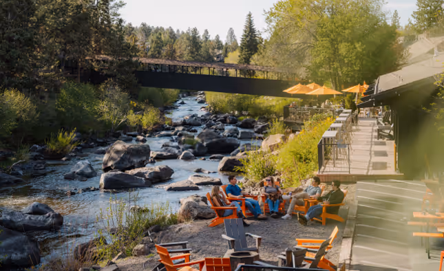 Exterior photo of people enjoying their evening outside the River House Resort.
