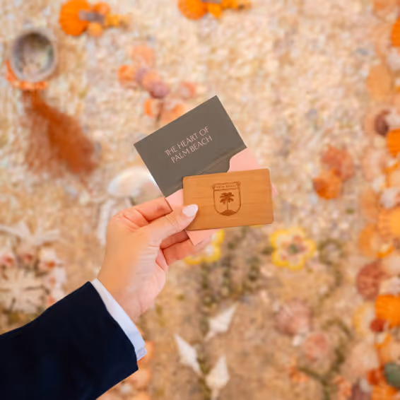 An hand holding up hotel room keys.