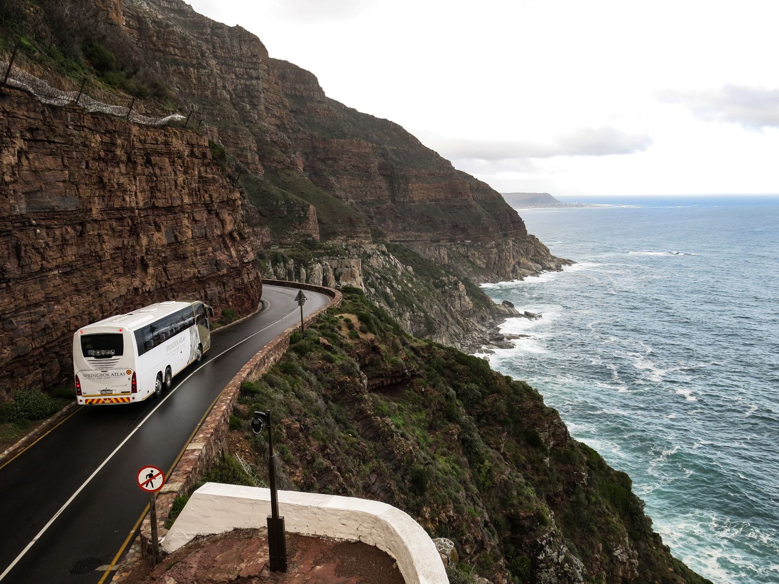 White charter bus on a scenic road