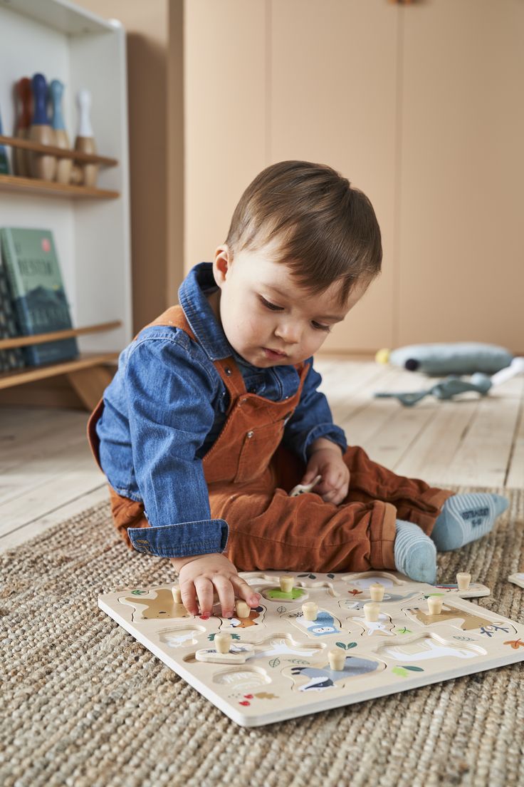 A toddler playing with a puzzle.