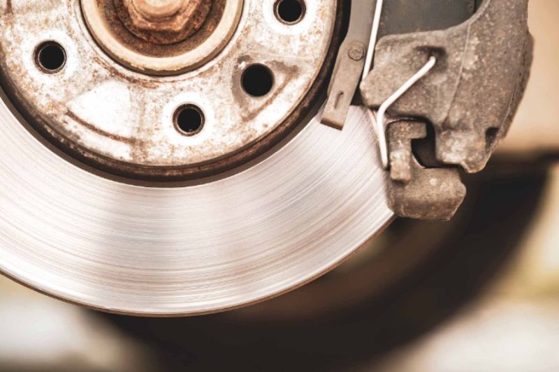 Close-up of a commercial vehicle brake rotor and caliper, highlighting brake system components essential for safe stopping performance.