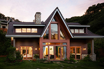 Modern vacation rental home with large windows and warm lighting, representing Bozeman property management and short-term rental oversight.