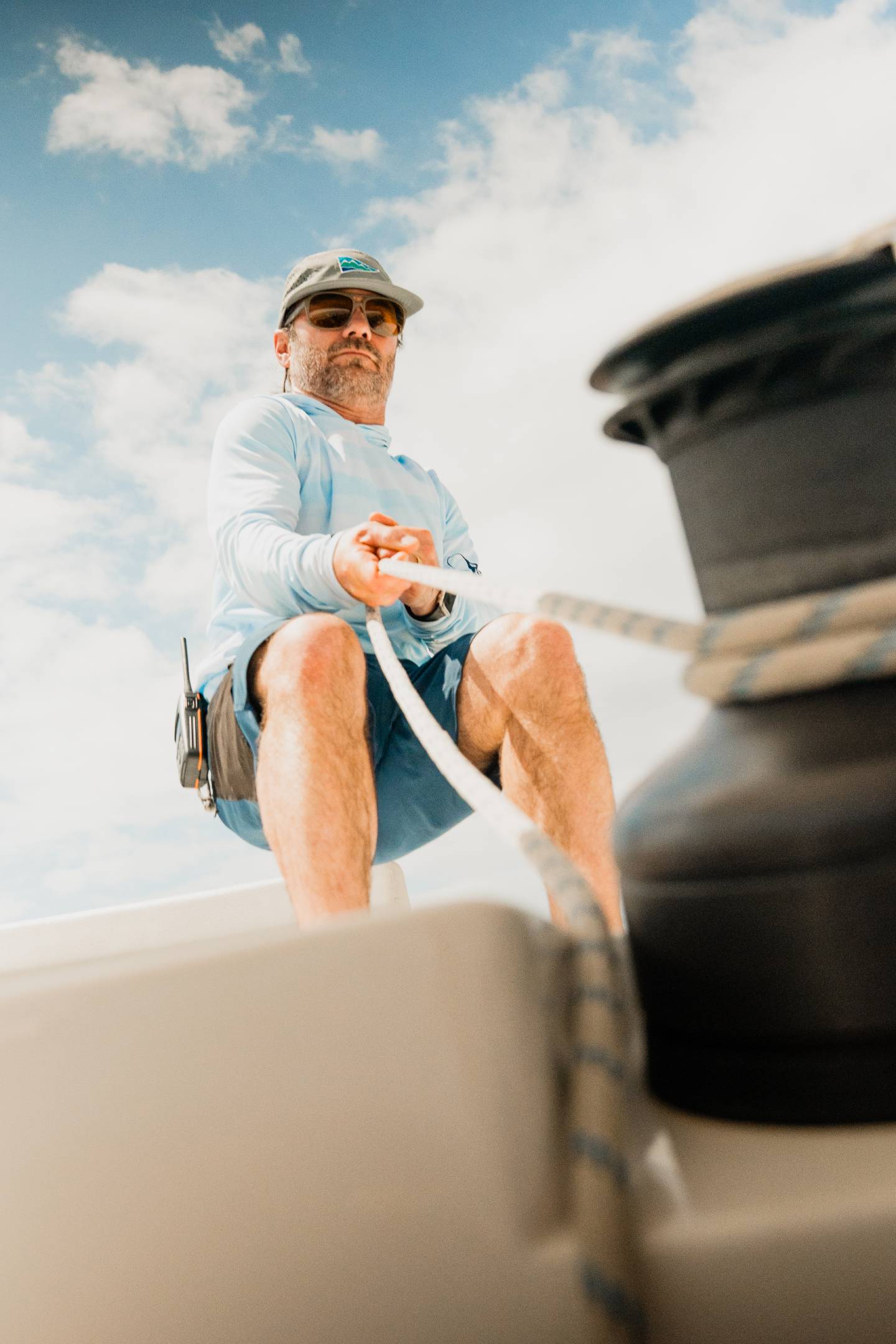 Crew member working the lines on a catamaran