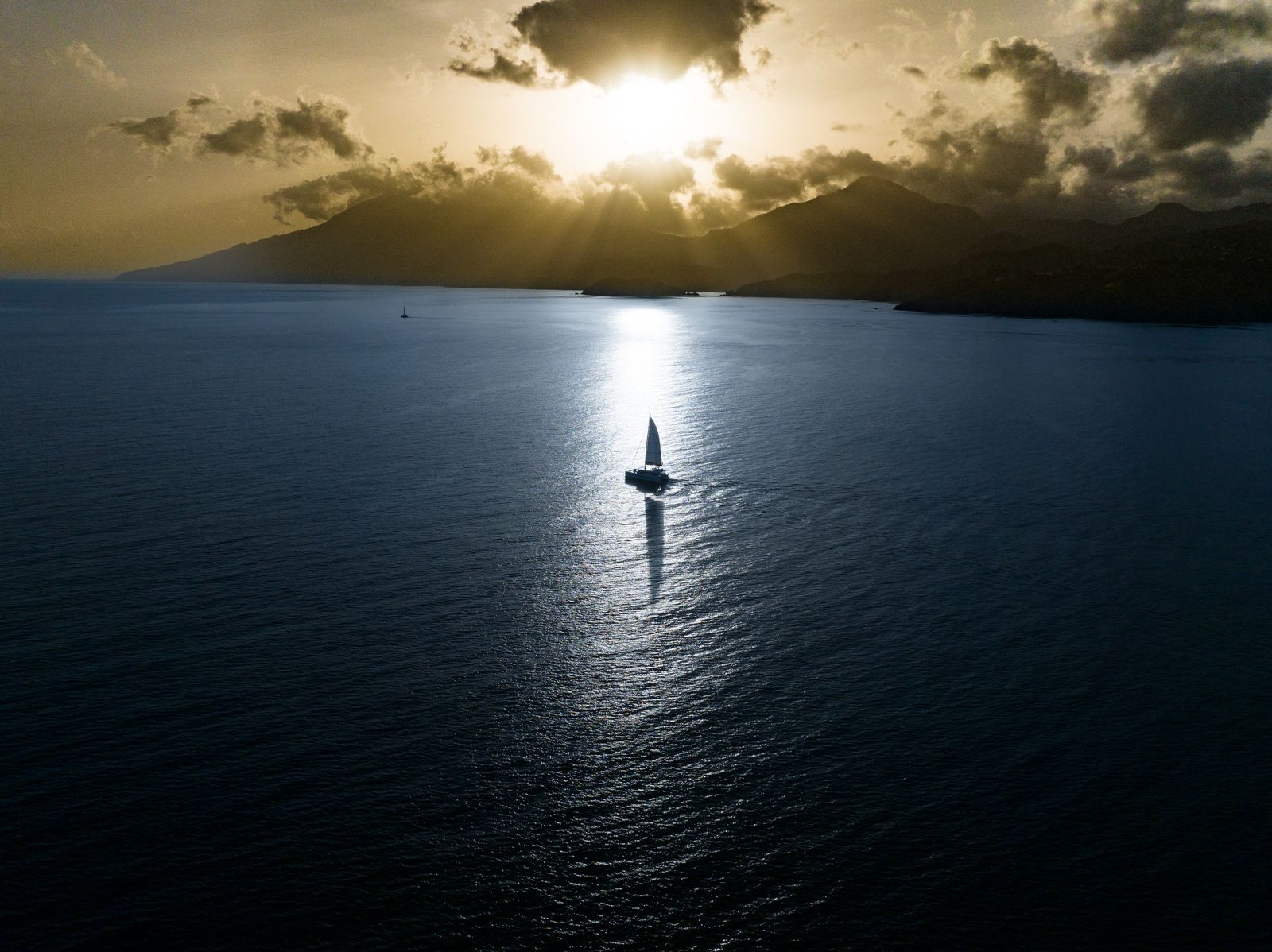 Catamaran sailing at sunrise