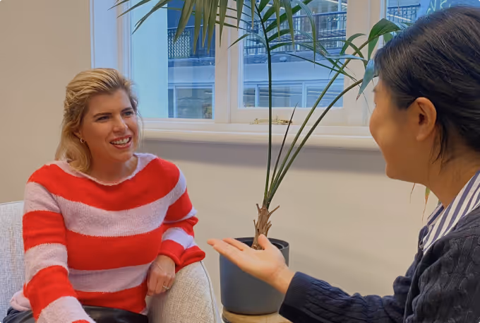 Purple Shirt employees, happy, having a one on one meeting