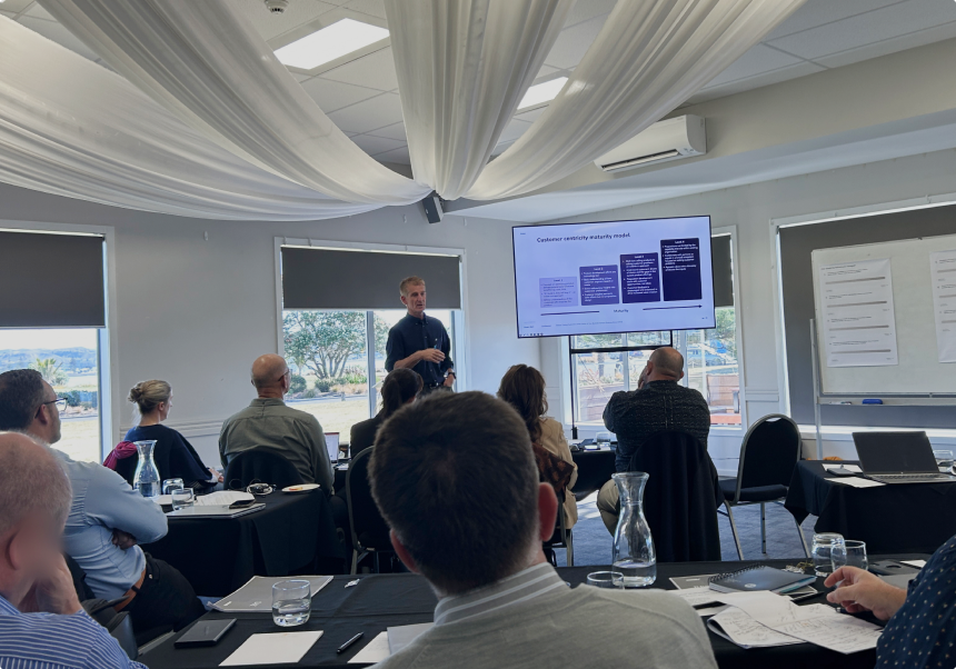 Purple Shirt presenting to a group of people