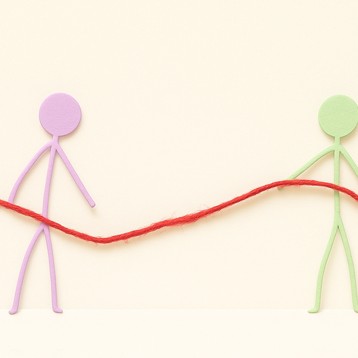 Two simple paper stick figures holding a red thread between them, symbolizing connection, communication, and support.
