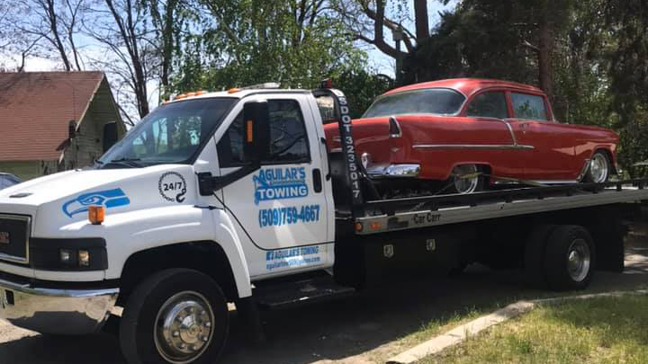 Aguilar's Tow Truck transporting Vintage Car with care