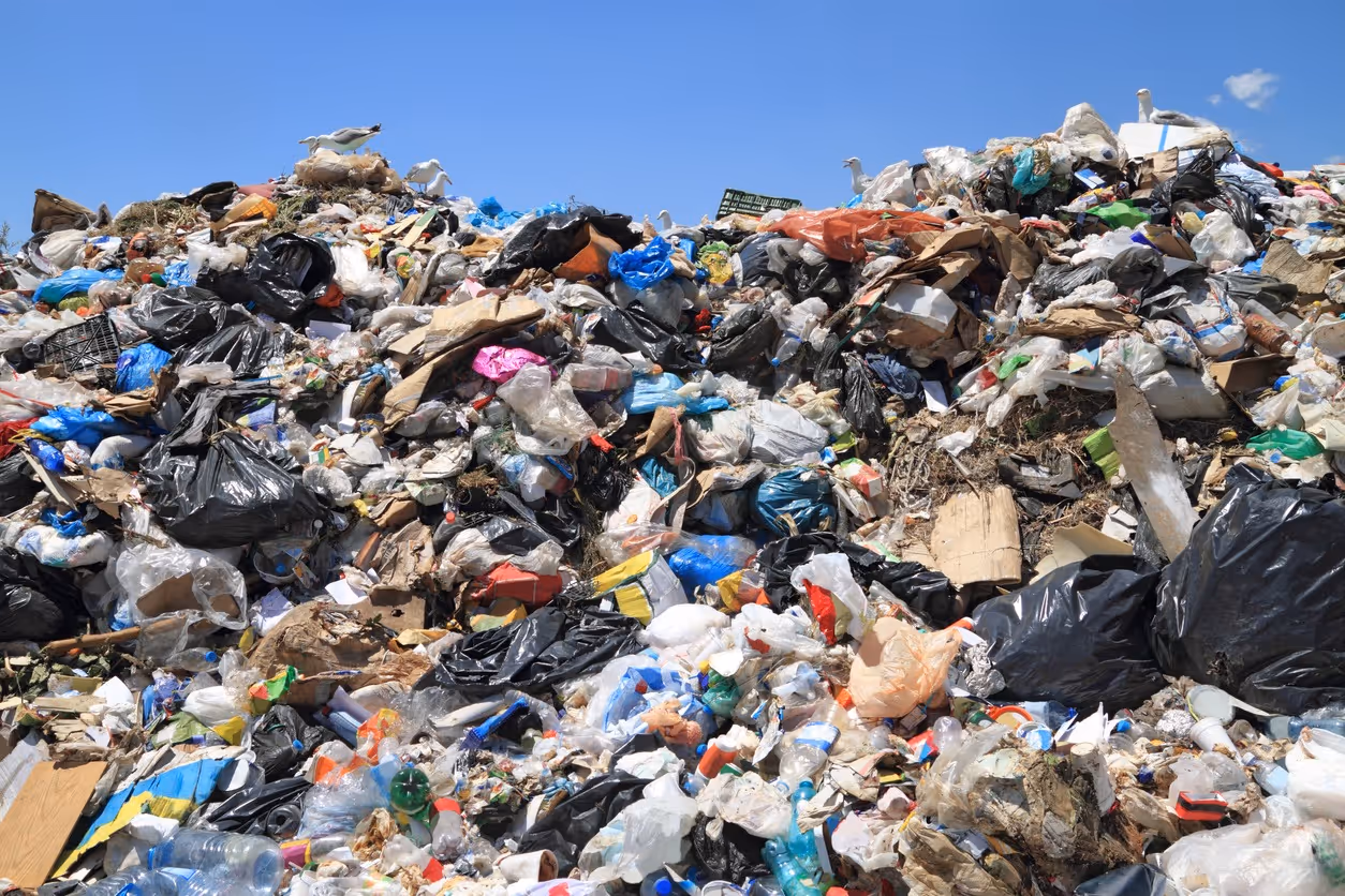 Piles of municipal solid waste representing biomass feedstock for AER Energy gasification