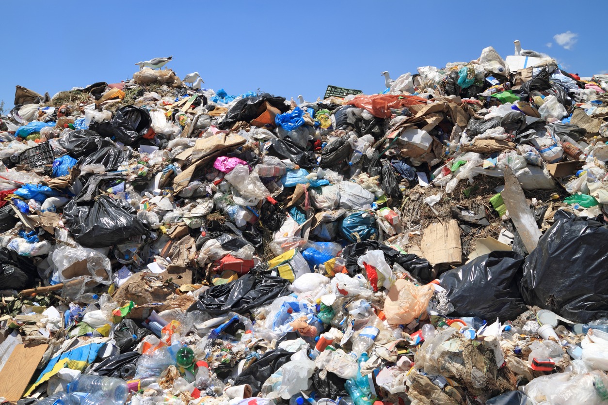 Piles of municipal solid waste representing biomass feedstock for AER Energy gasification