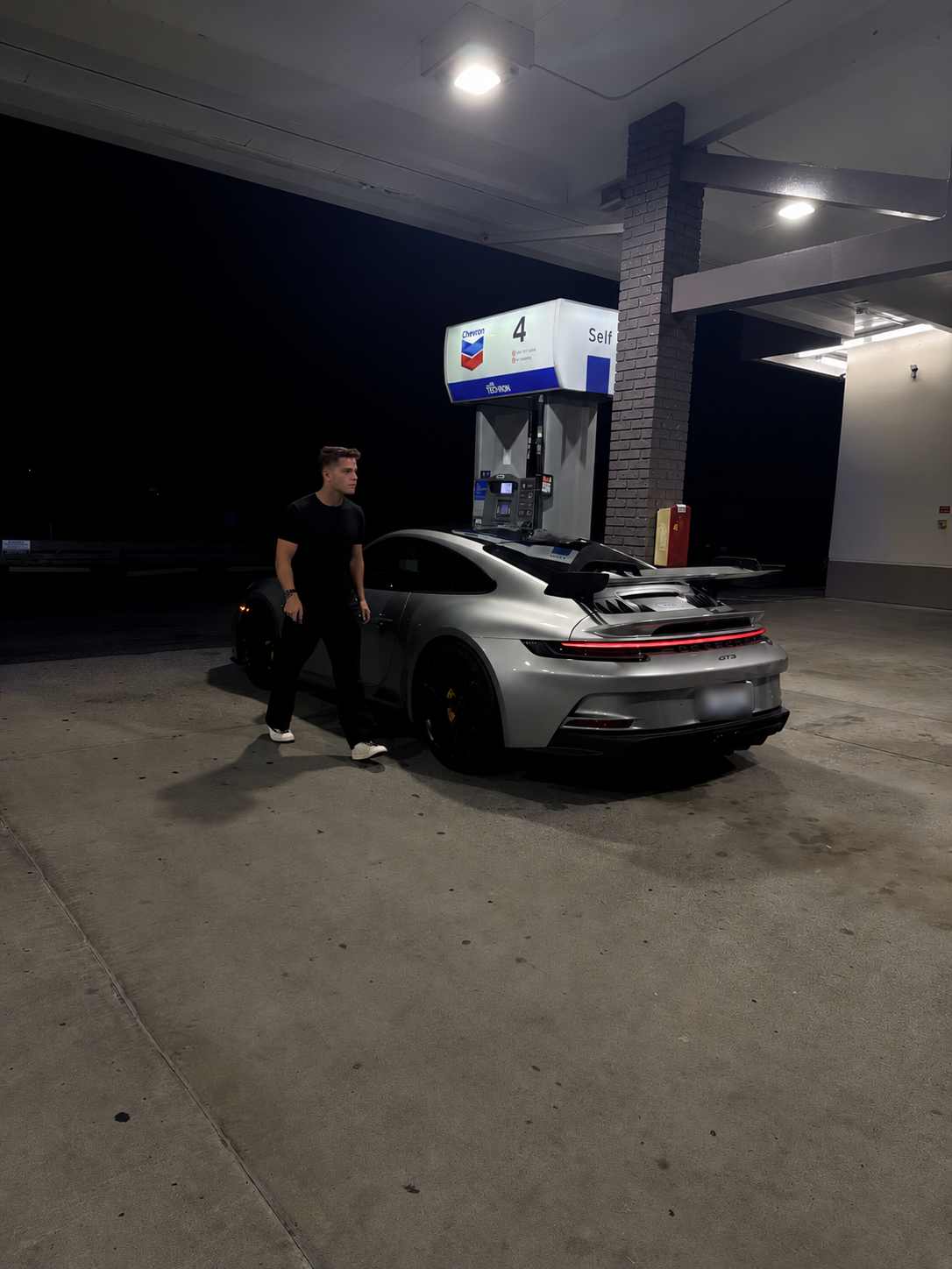 Carson Reed with his Porsche at night; license plate blurred