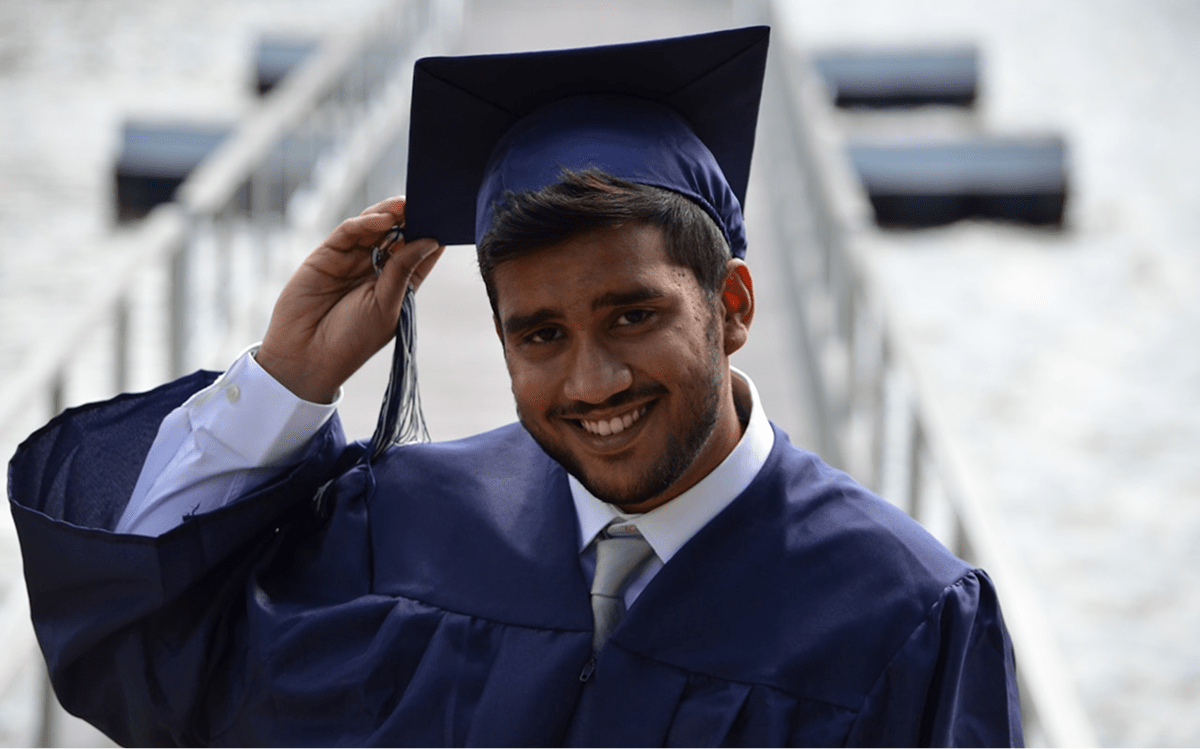 A student smiling wearing toga
