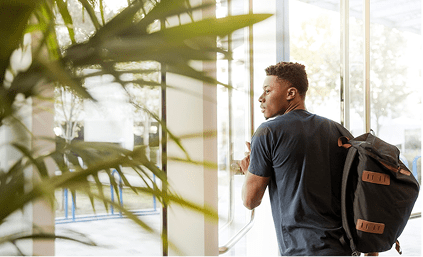 a young adult male going out of the building