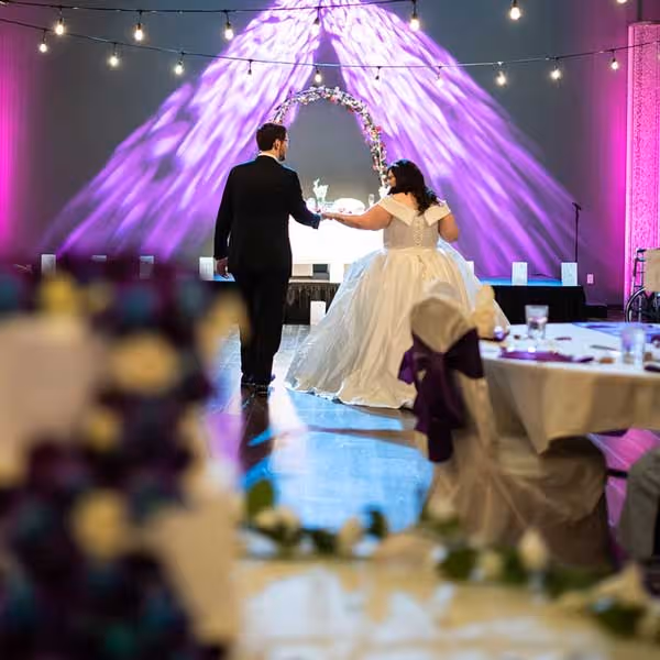 A recently wedded bride and groom take their first dance.