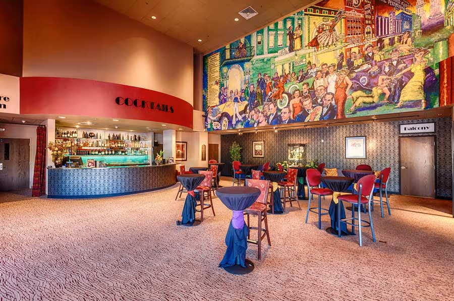 The interior of Arizona Broadway Theatre's lobby, showcasing the concessions bar and intricate mural.